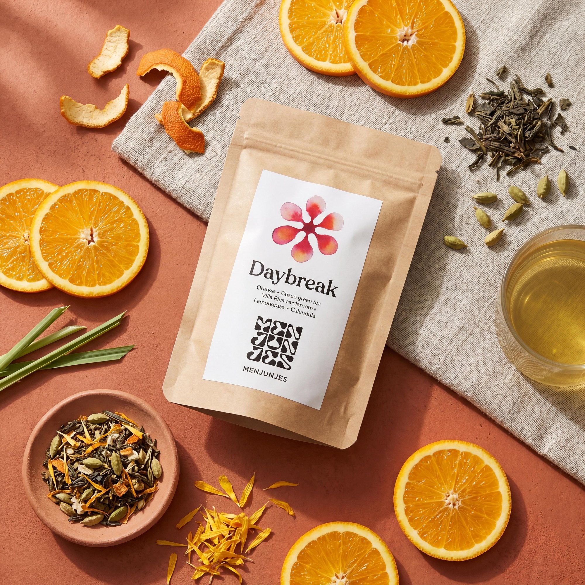 Daybreak pouch with loose tea and citrus, styled flatlay