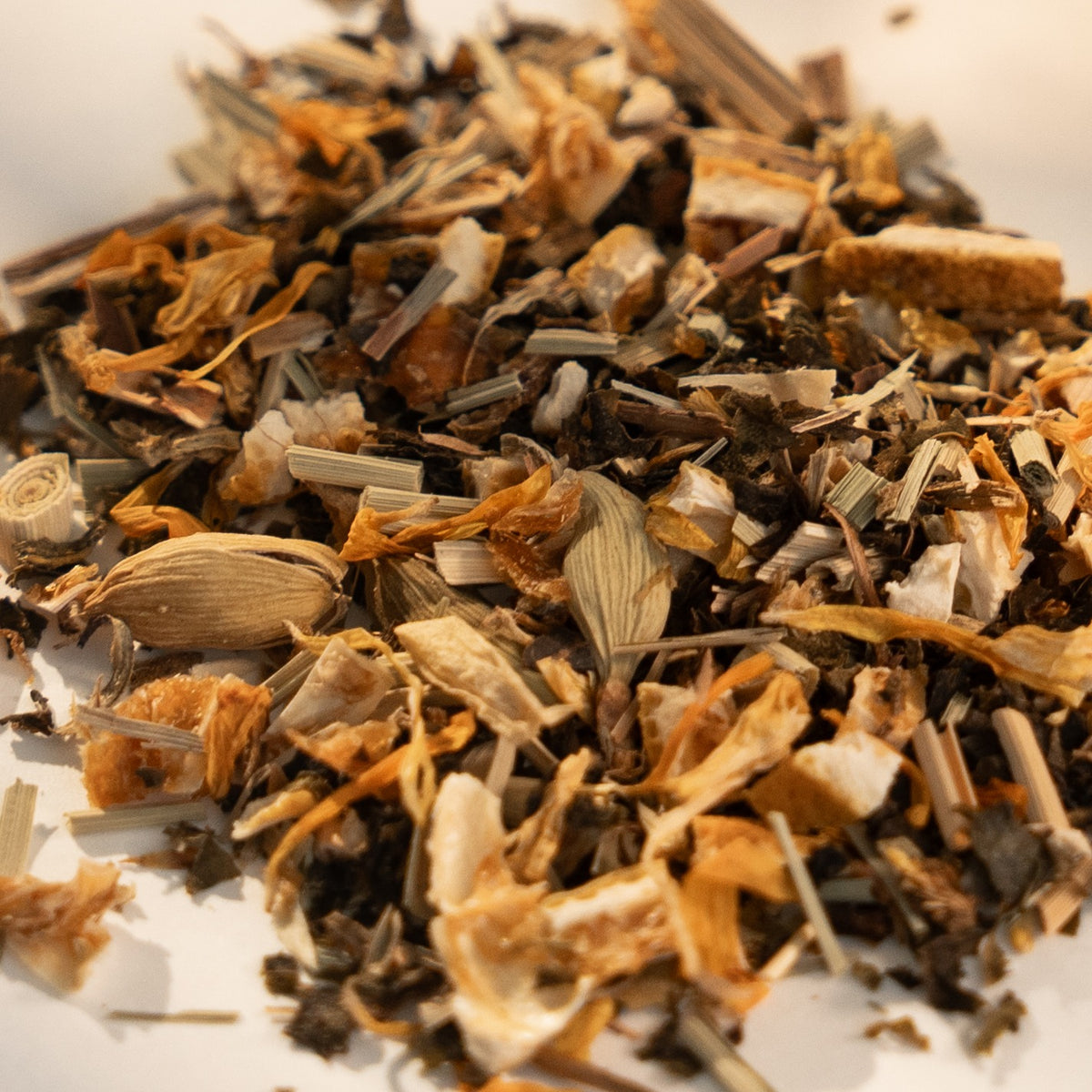 Daybreak loose leaf up close: lemongrass, calendula petals, orange peel and a cardamom pod