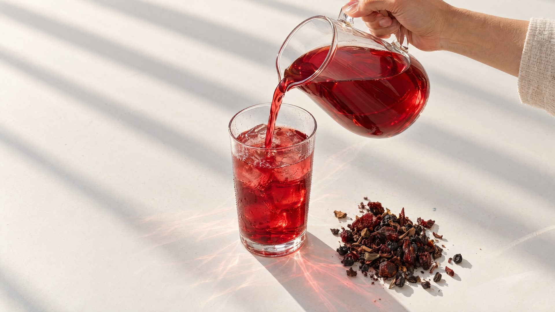 Gather poured from a glass pitcher over ice, with a pile of the loose blend beside the glass