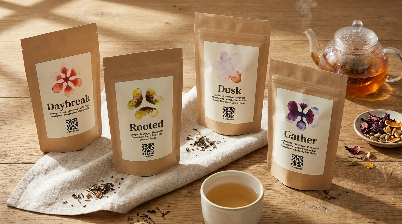 Daybreak, Rooted, Dusk, and Gather loose-leaf pouches on linen beside a brewing teapot