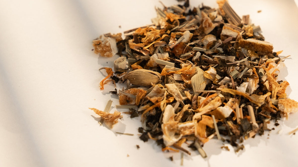 Daybreak's loose blend up close, with whole green cardamom pods among the lemongrass, orange peel and calendula