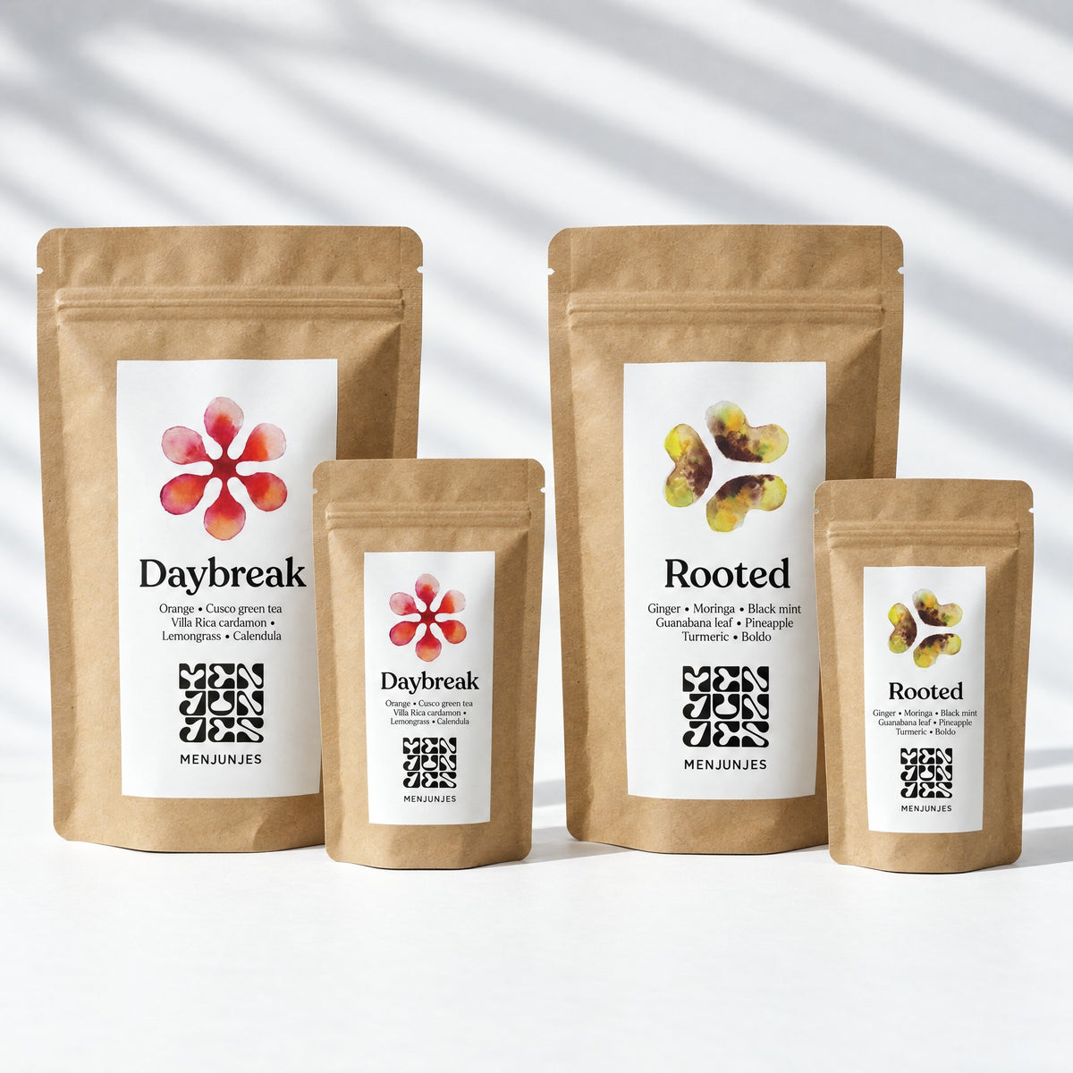 What arrives: a 200 g bag and a 50 g pouch of Daybreak, and a 200 g bag and a 50 g pouch of Rooted, standing on white paper.